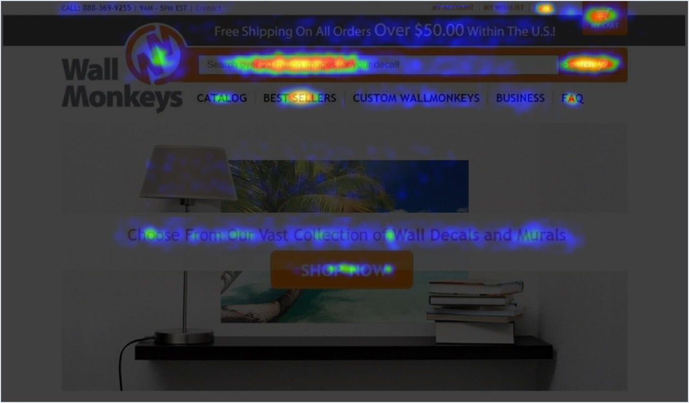 A heatmap overlay on the Wall Monkeys ecommerce homepage using a blue-to-red color scale, with hot spots concentrated on the search bar, search button, and shopping cart icon in the header.
