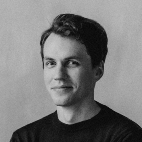 Grayscale portrait of a man against a plain background.