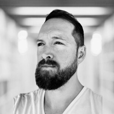 Black-and-white portrait of a bearded man.