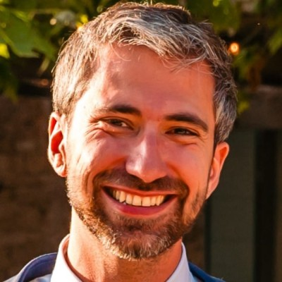 Headshot of Alex Lavergne smiling outdoors.